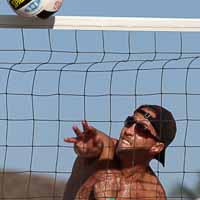 Client Todd Stevens hammers a set to the sand.